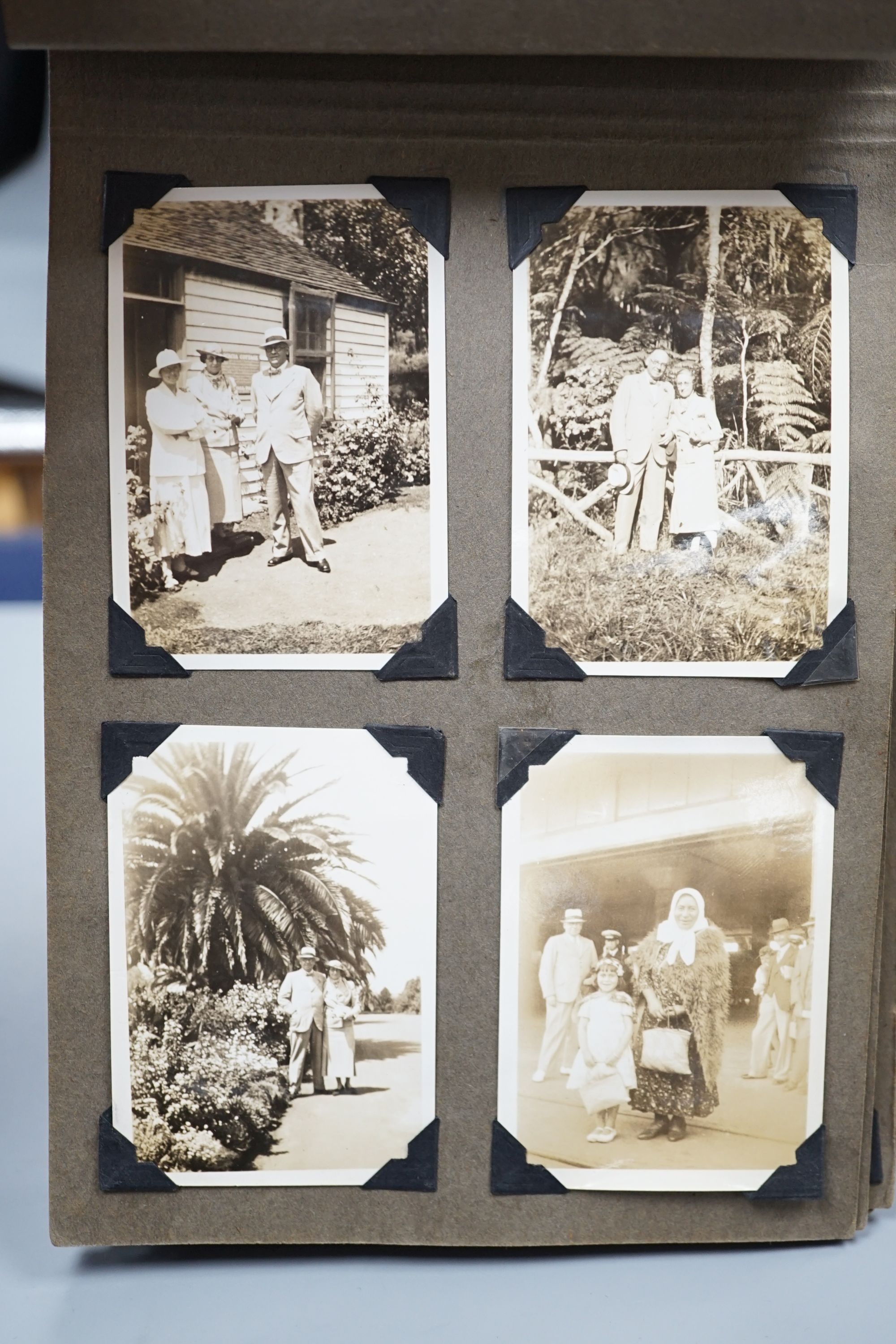 A collection of postcards, a photo album and an album of silks
